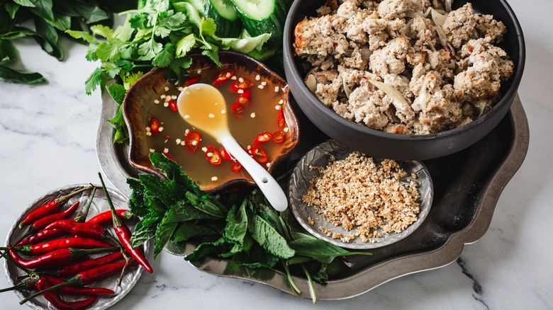 Turkey wrap ingredients on a metal tray with red chilies