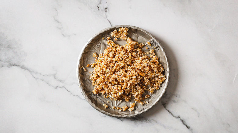 Ground rice in metal pinch bowl