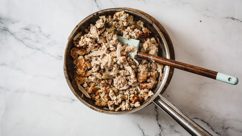 Cooked turkey filling in pan with spatula