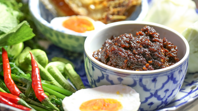 nam prik pao in bowl with vegetables