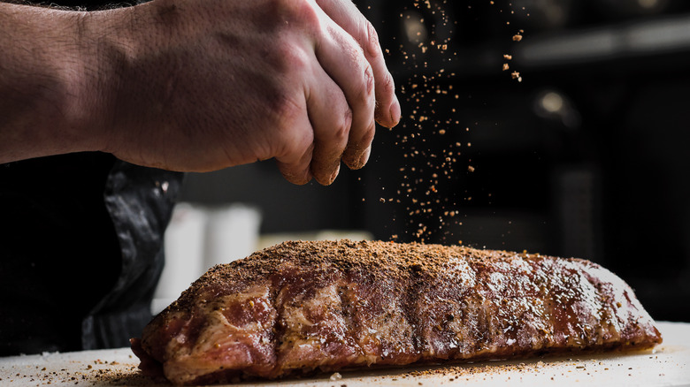 Hand seasoning steak