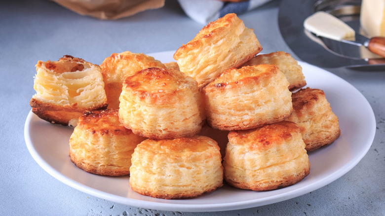 Fluffy biscuits stacked on plate