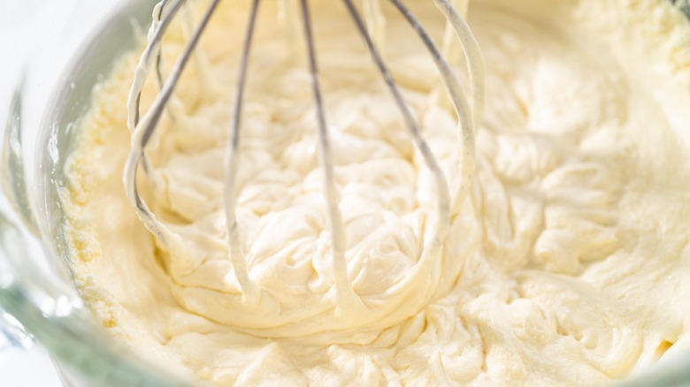 whipping vanilla frosting in bowl