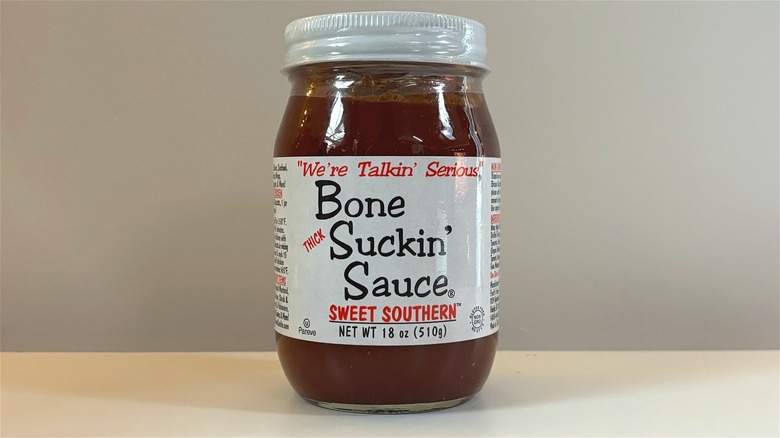 Jar of Bone Suckin' Sweet Southern BBQ sauce on white table