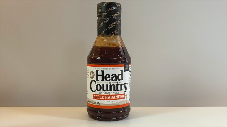 Bottle of Head Country Apple Habanero Bar-B-Q Sauce on white table