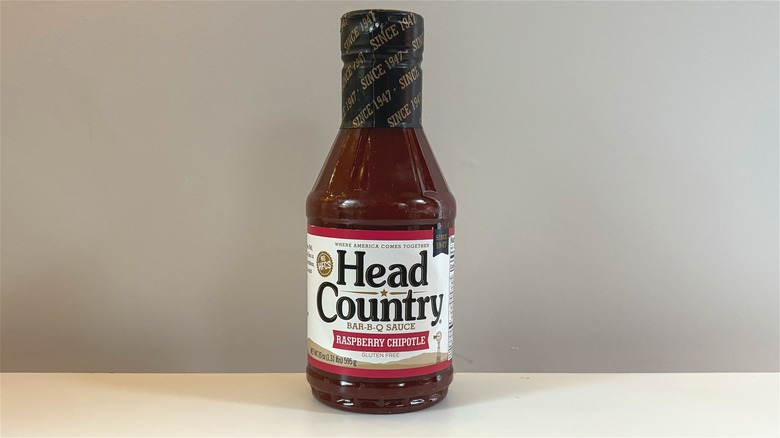 Bottle of Head Country Raspberry Chipotle Bar-B-Q Sauce on white table