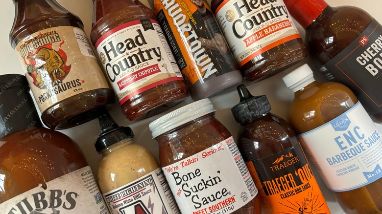 Barbecue sauce bottles on white table