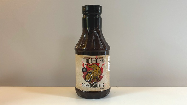 Bottle of Porkosaurus Memphis Original BBQ Sauce on white table