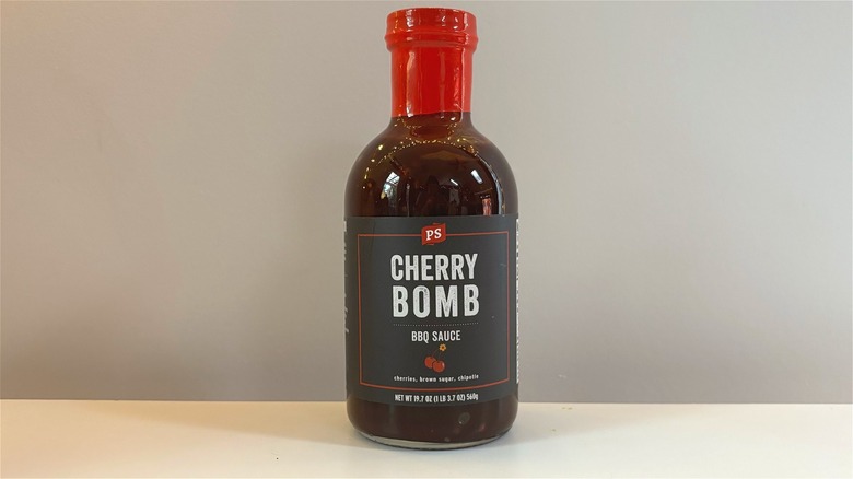 Bottle of PS Cherry Bomb BBQ Sauce on white table