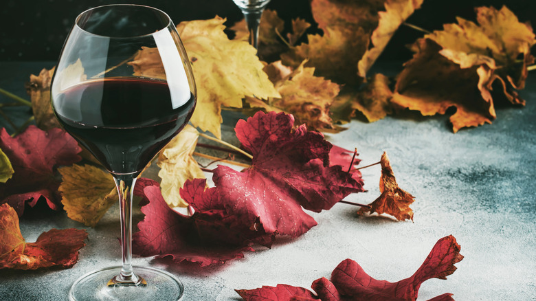 red wine glass with leaves