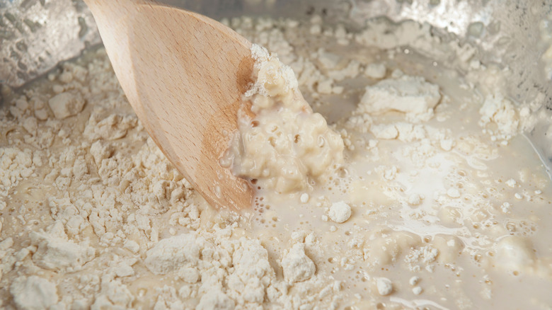 Wooden spoon mixing dough