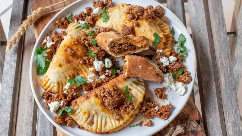 Meat-filled pierogi with toppings