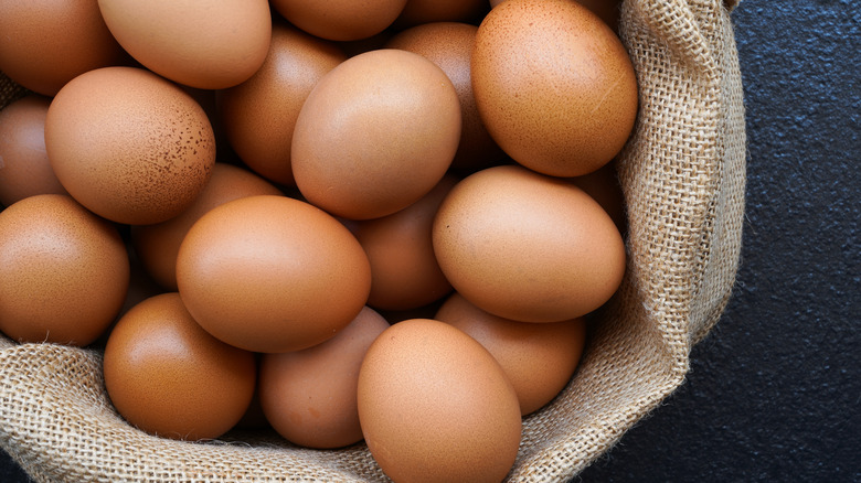 Fresh brown eggs in burlap