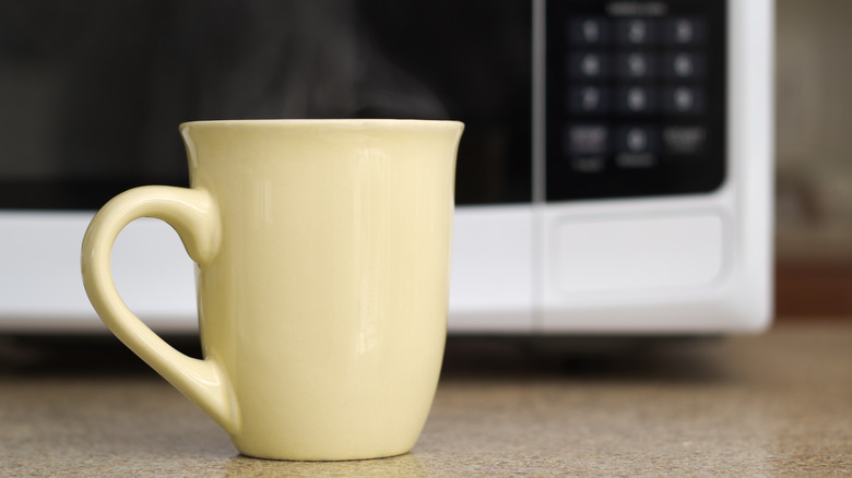 Mug steaming in front of microwave