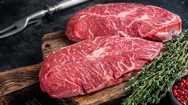 Two raw blade steaks.