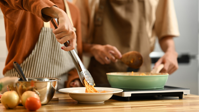 Plating pasta from pan and induction burner