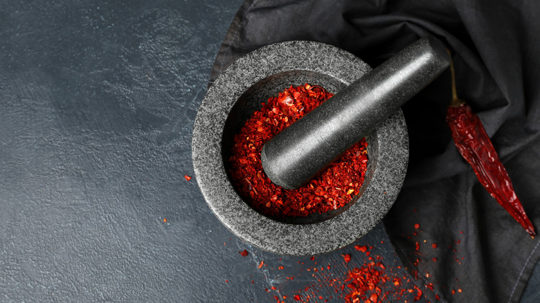 Mortar and pestle with red chiles