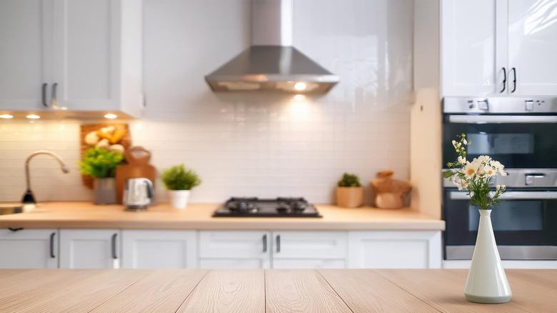 Kitchen counter with stove and range in the background