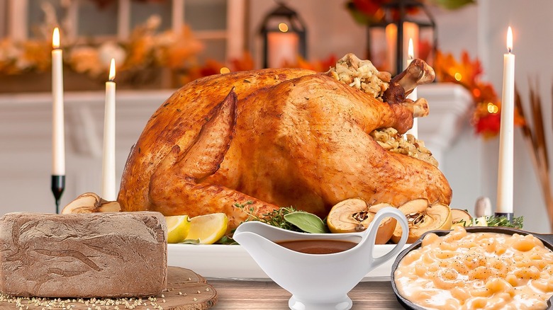 Table filled with a Thanksgiving meal in front of autumnal decorations