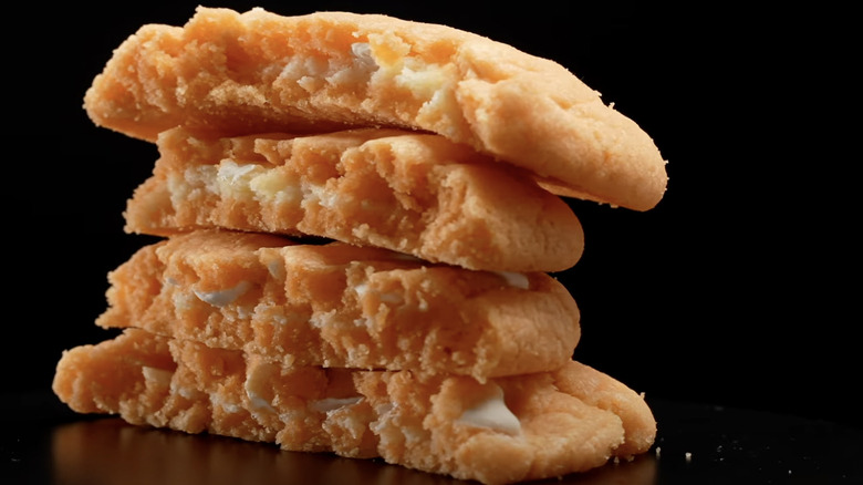 Stack of 4 orange cookies with white interior