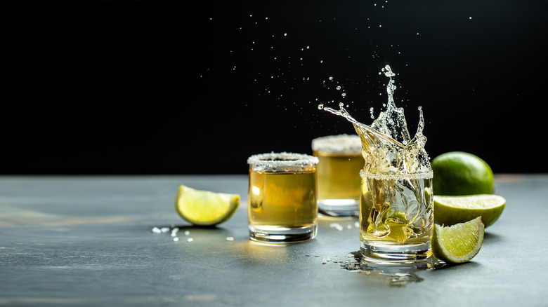 Golden tequila shots with lime