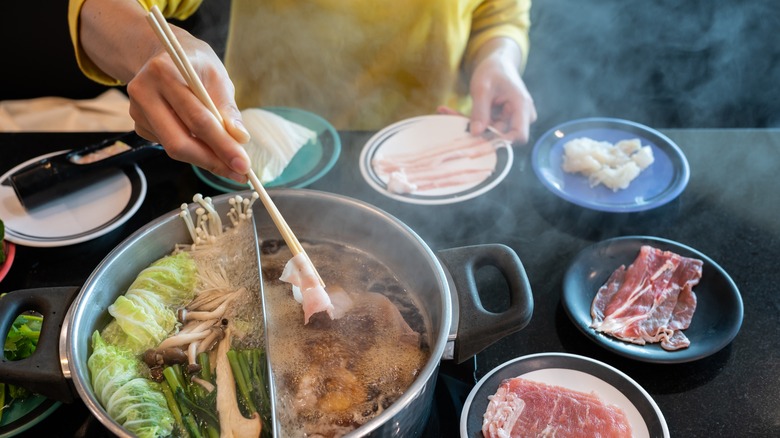 dipping meat in hot pot