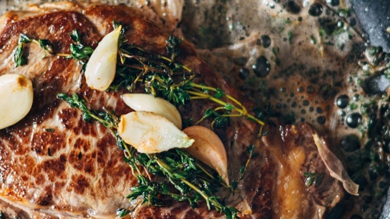 steak cooking in pan