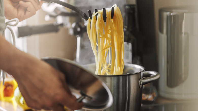 spaghetti pulled from pot