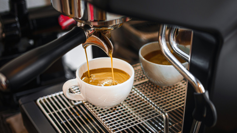Espresso shot pouring out of an espresso machine nozzle