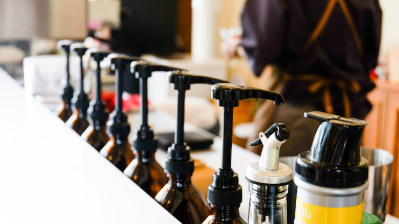 Line-up of coffee syrup pumps on a café counter