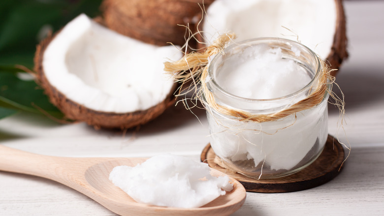 Coconuts on table with oil