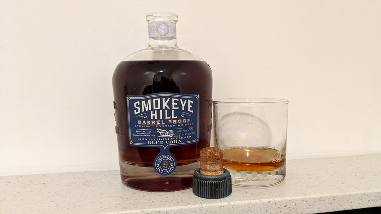 Smokeye Hill Barrel Proof Straight bourbon bottle on shelf in front of white wall