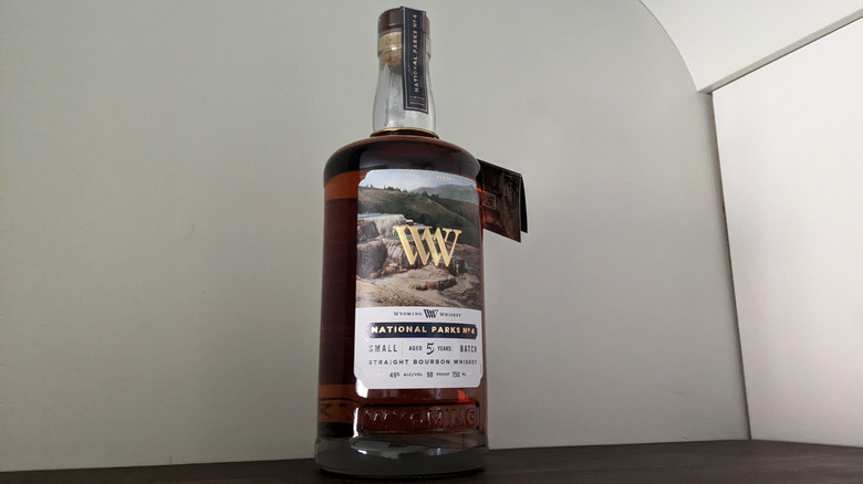 Wyoming Whiskey National Parks No.4: Mammoth Hot Springs bottle on wooden table in front of white wall