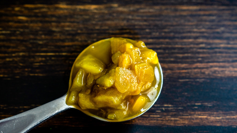 Canned green chiles on spoon