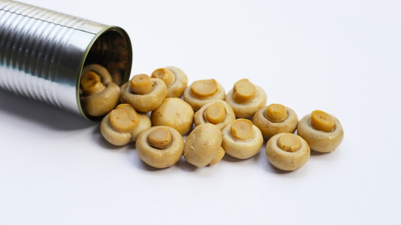 Canned mushrooms spilling from can