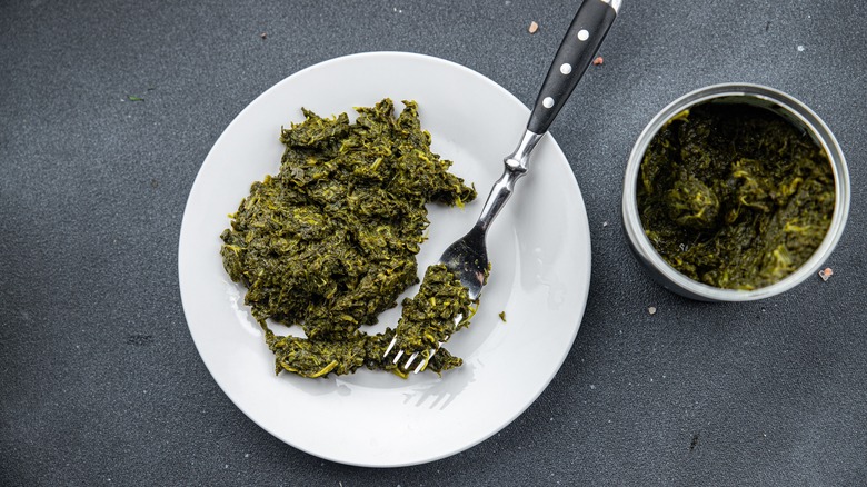 Canned spinach on white plate