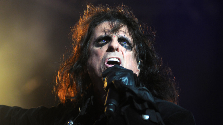 Alice Cooper singing into microphone