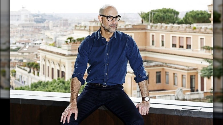 Stanley Tucci leaning on a ledge