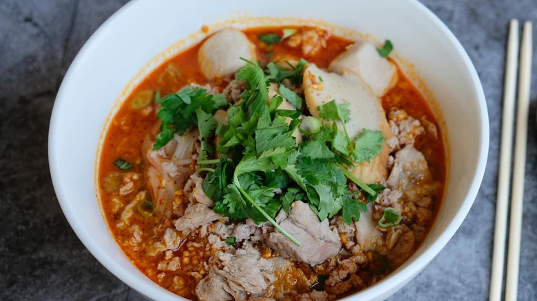 bowl with red soup ground pork