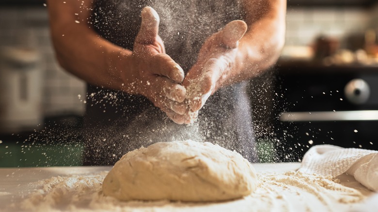 Dusting flour over pastry dough