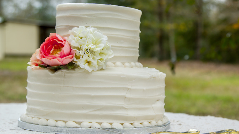 white two tiered cake with flowers