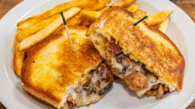 Black and Blue's vegan breakfast sandwich served with fries on white plate