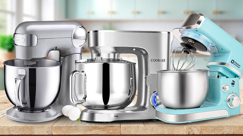 Three stand mixers on a wooden countertop