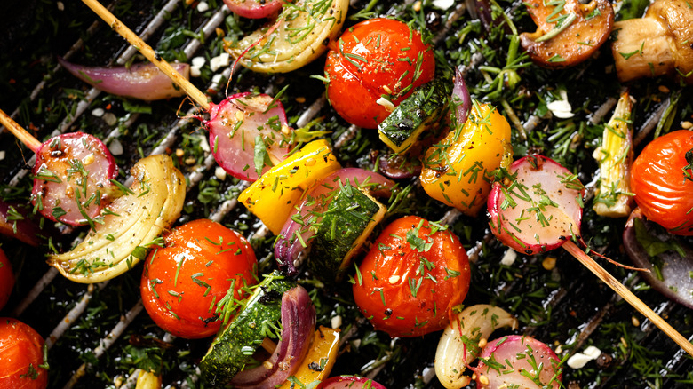 Veggie skewers with seasoning on grill