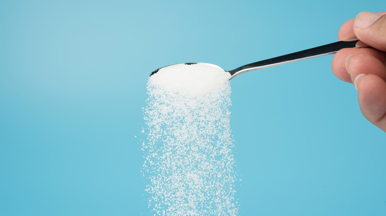 Pouring sugar from spoon