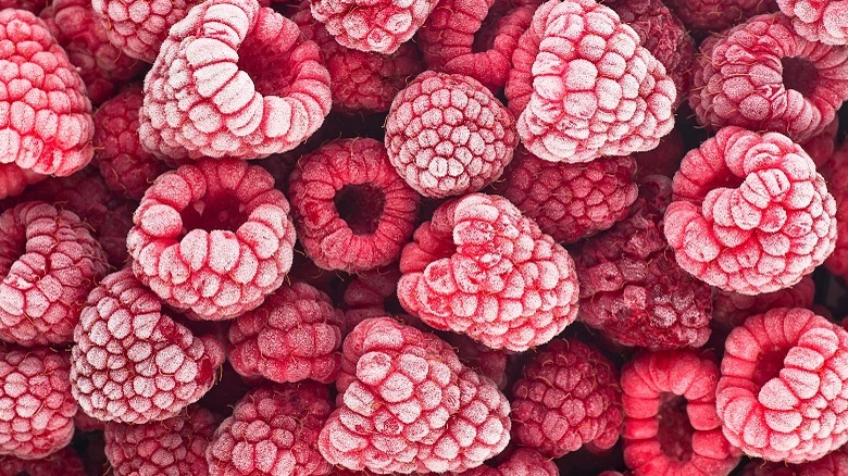 Scattered frozen raspberries