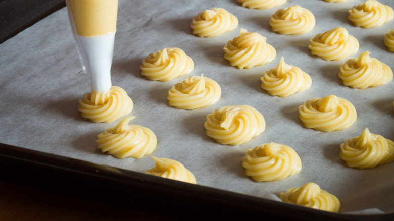 Piping choux onto baking sheet