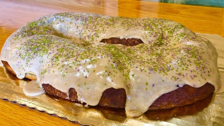 Brown cake on gold sheet with white icing