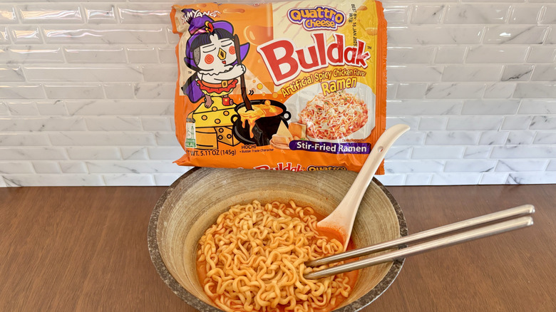 Buldak quattro cheese ramen packet on bowl of ramen