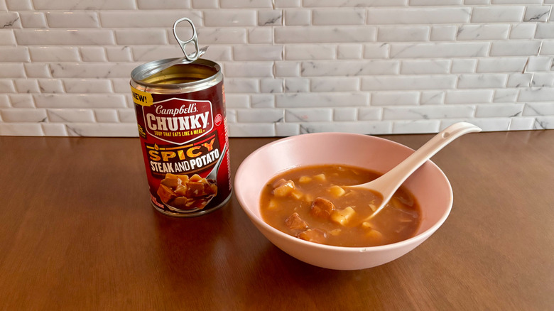 Campbell's can of soup next to bowl of soup